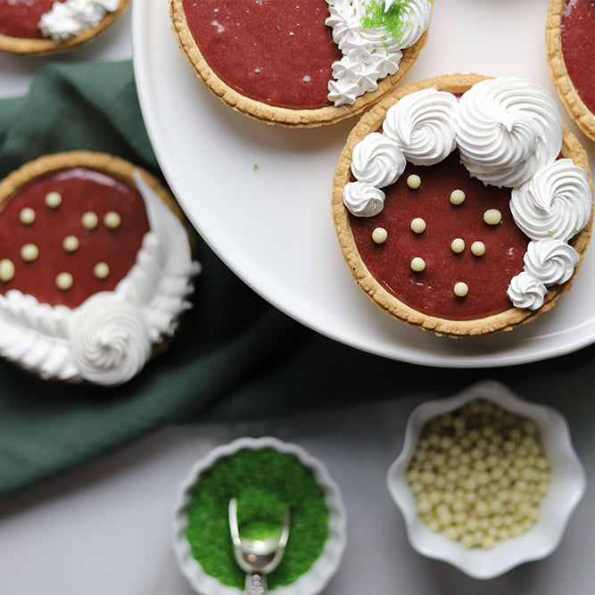 Image of Cranberry Curd Meringue Tarts with assorted sugar decor 