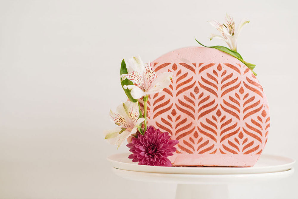 Top Forward Cake covered in Raspberry buttercream, embellished with Ruby Brilliant Powder and fresh flowers.