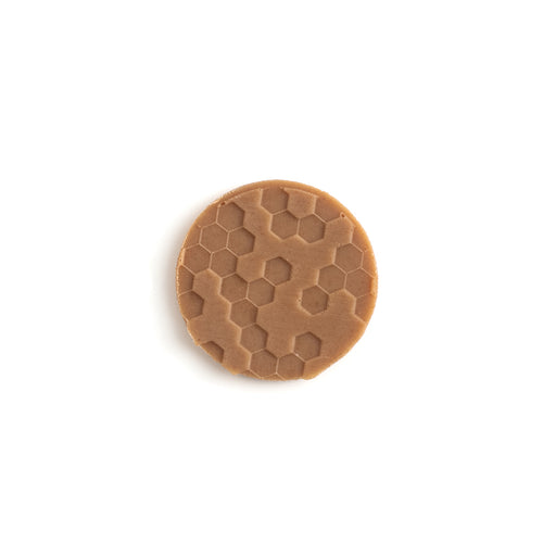 Blonde Chocolate Disk with an Embossed Honeycomb Pattern