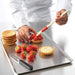 Chef assembing strawberry tarts
