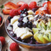 acai roots superfood smoothie bowl packed with fruit, nuts and seeds