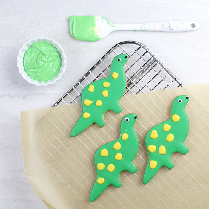 Brontosaurus shaped cookies decorated with colored chocolate icing