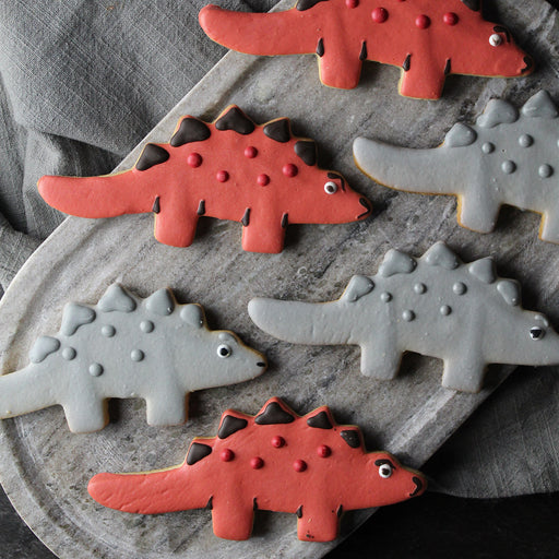 Red and Grey Assorted Cookies in shape of stegosaurus dinosaurs