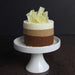 triple mousse cake topped with white chocolate shavings