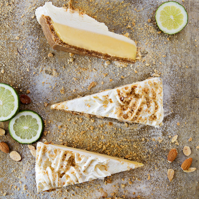 3 slices of key lime pie with limes and almonds